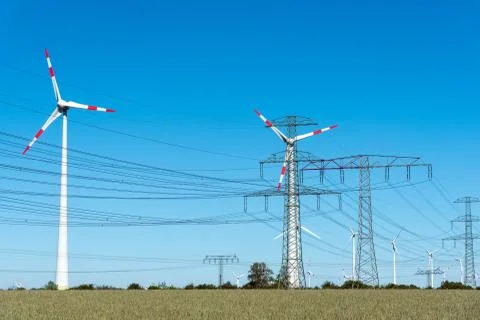 Windwheels and power transmission lines in Germany Stock Photos