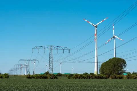 Windwheels and power transmission lines in Germany Stock Photos
