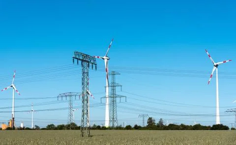 Windwheels and power transmission lines in Germany Stock Photos