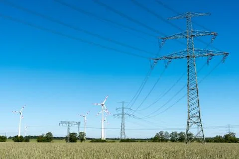 Windwheels and power transmission lines Stock Photos
