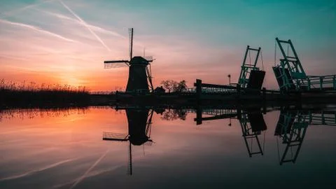 Windwill at sunset in The Netherlands. Stock Photos