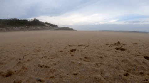 Windy Beach Cornwall With Sand Blowing Towards Camera Video stock 106382372