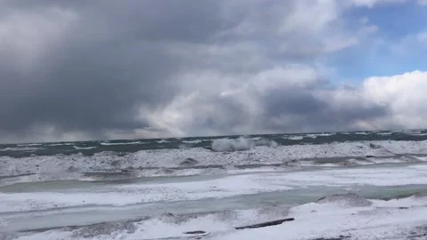 Windy, clouding day on built  icy shoreline Stock Footage 169546145