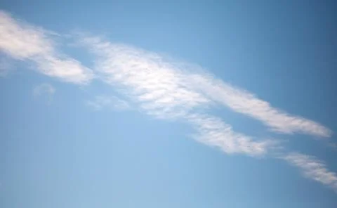 Windy clouds on the blue sky. Background Texture Photos