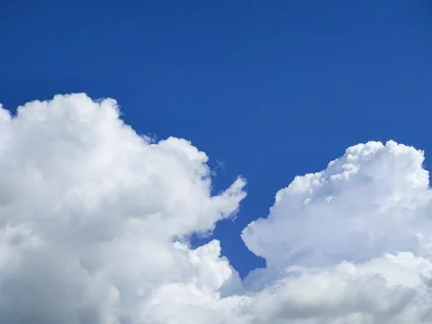 Windy clouds on blue sky Stock Photos