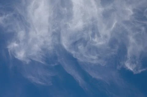 Windy Clouds In A Blue Sky Stock Photos