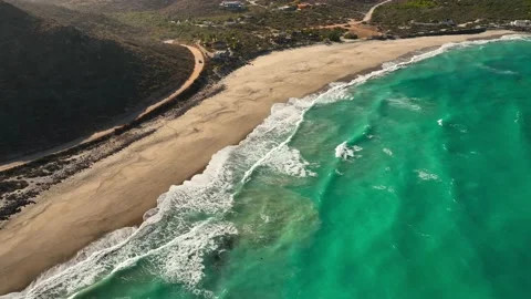 Windy day aerial view of waves crashing on the beach rolling in Stock Footage 236742082
