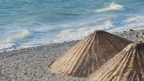 A windy day on a tranquil beach. Gentle waves roll onto the shore as a brisk Vídeos de archivo 317844740