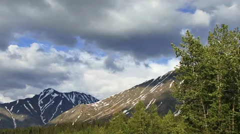 Windy Stormclouds over Alaskan Mountains with Tree 24p Stock Footage 12440452