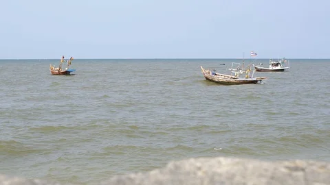The windy waves caused the flag to shake. Wobbling fish boat, Thailand Stock Footage 128674669