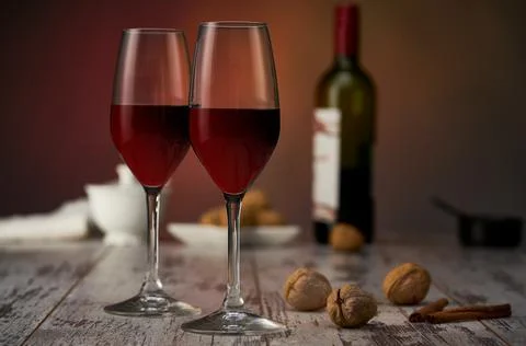 Wine and nuts on the table Stock Photos