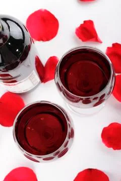 Wine and rose petals Stock Photos