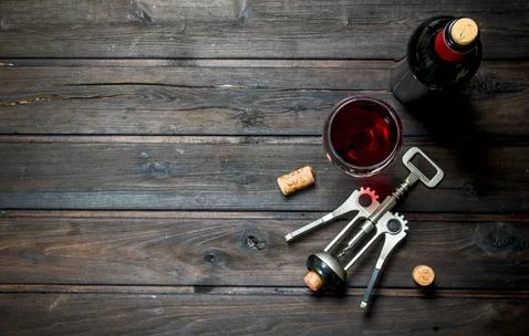 Wine background. Red wine with corkscrew. Stock Photos