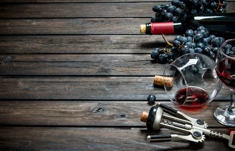 Wine background. Red wine with corkscrew. Stock Photos