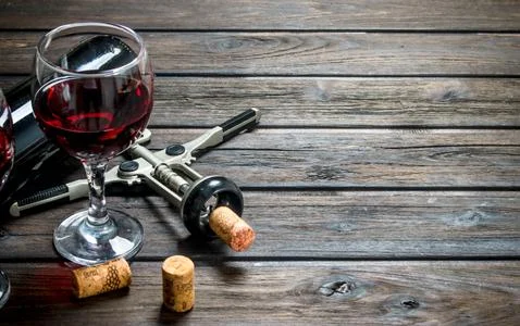 Wine background. Red wine with corkscrew. Stock Photos