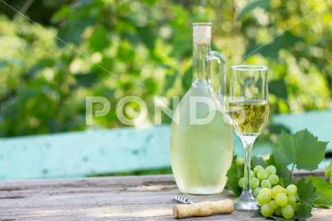 Wine background, wine concept. White wine bottles on wooden table. Stock Photos