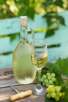 Wine background, wine concept. White wine bottles on wooden table. Fotos Stock