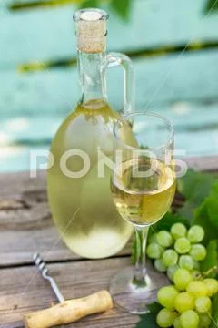 Wine background, wine concept. White wine bottles on wooden table. Stock Photos