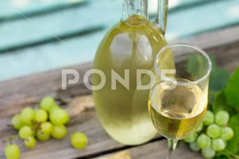 Wine background, wine concept. White wine bottles on wooden table. Stock Photos