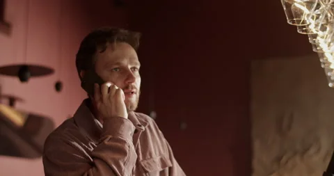 Wine bar owner talking to client reserving table on cellphone Stock Footage 239168939