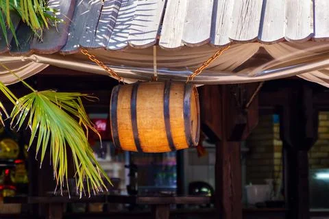 Wine barrel on chains suspended from the ceiling of the restaurant Stock Photos