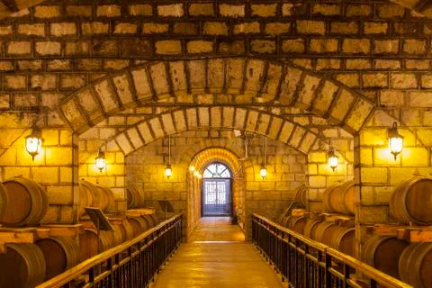 Wine barrels stacked in the cellar Stock Photos