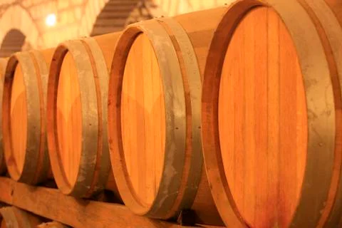 Wine barrels stacked in the cellar Stock Photos
