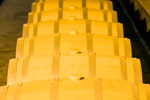 Wine barrels stacked in the cellar Stock Photos