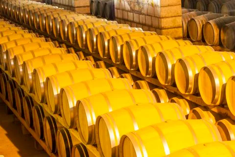 Wine barrels stacked in the cellar Stock Photos