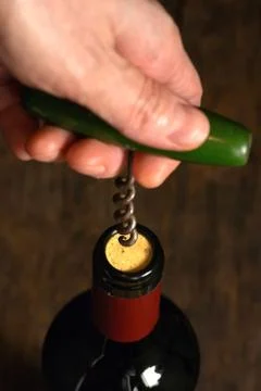 Wine Bottle And Corkscrew Isolated On Black Stock Photos