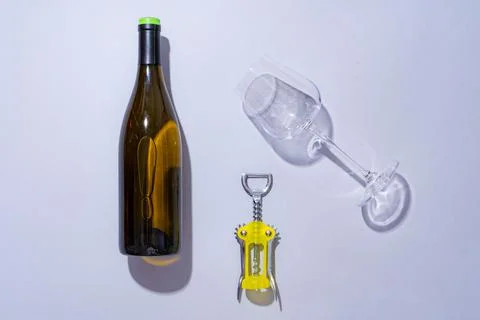 Wine bottle and glass on gray background flat lay Stock Photos
