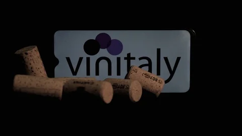 Wine bottle caps that fall on a smartphone with Vinitaly logo in slow motion. Stock Footage 125643491