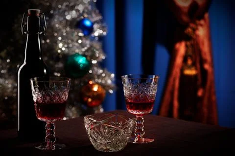 Wine bottle with a crystal glass standing on a table. Blue backg Stock Photos