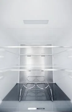 Wine bottle holders in the cold storage compartment. An empty refrigerator Stock Photos