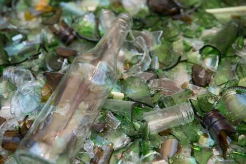Wine bottle lying on a bed of broken glass having escaped the crusher at a re Stock Photos
