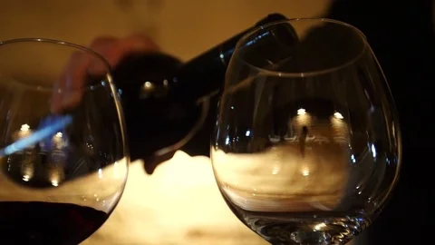 Wine from the bottle is poured into a glass Stock-Footage 80949203