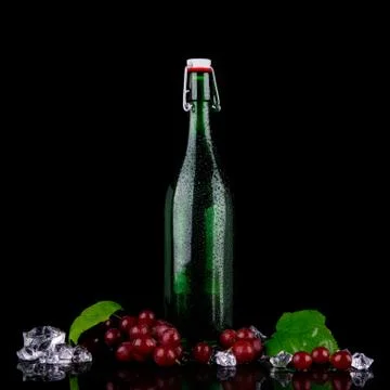 Wine bottle with red grape Stock Photos