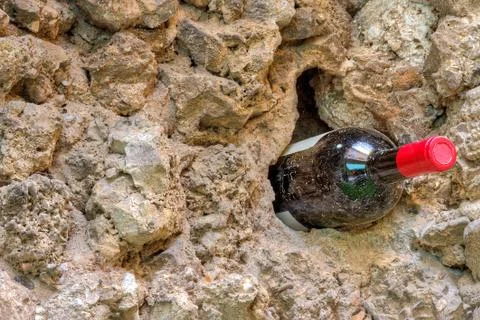 Wine bottle by a rustic old wall Stock Photos