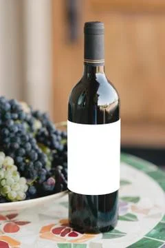 Wine Bottle on a Table with Blank Label Stock Photos