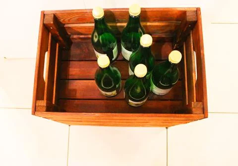 Wine bottles in a box close up. Box with bottles of drink in a wooden box on a Stock Photos
