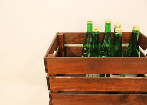 Wine bottles in a box close up. Box with bottles of drink in a wooden box on a Stock Photos