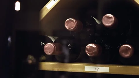 Wine Bottles Displayed in Beautiful Cabinet with Diagonal Compartments Stock Footage 246852354
