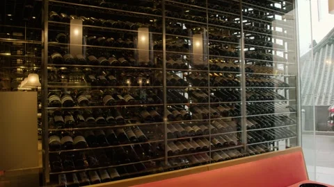 Wine Bottles Displayed in Glass Rack at Modern Restaurant Interior in Beijing Stock Footage 345779677