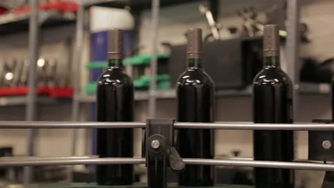 Wine bottles making a turn in the bottling machine Stock Footage 142736758