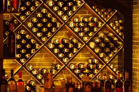 Wine bottles in rack at the store cellar Stock Photos
