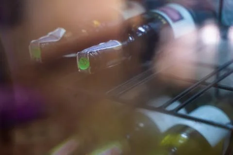 The wine bottles on the shelf use diffused light Stock Photos