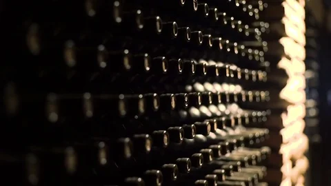 Wine bottles stacked in a cellar with shallow depth of field Stock Footage 71422988