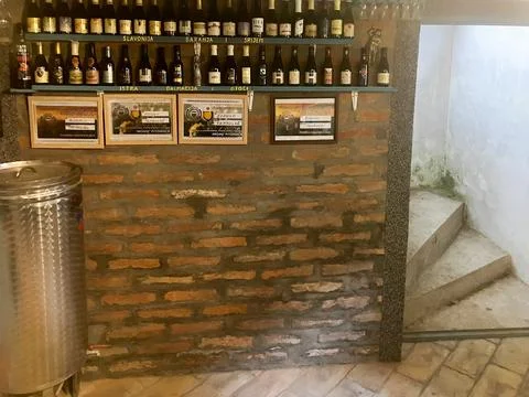 Wine Bottles Stored in Rustic Cellar Wall Display Stock-Fotos