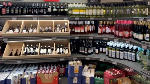 Wine in bottles of various types displayed on shelves Stock Footage 306892189
