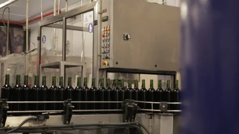 Wine bottles waiting in a bottling machine Stock Footage 142736735